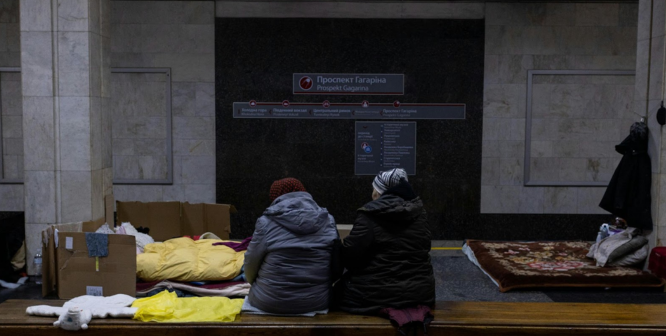 Elderly woman using a walking aid inside a designated tornado shelter, demonstrating safety measures for individuals.